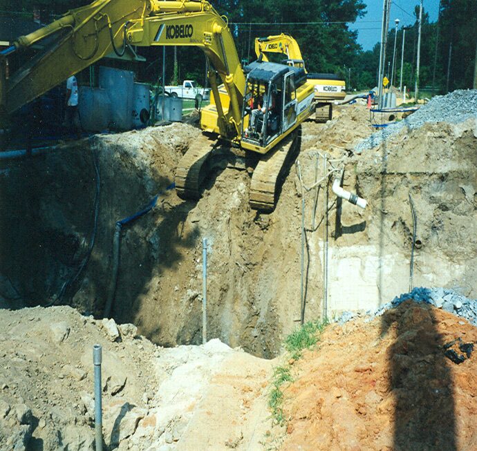 An excavator near a deep hole on the ground